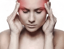 a woman is holding her head because she has a headache .