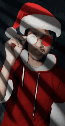 a man wearing a santa hat and red glasses