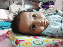 a baby laying on a pillow that says favorite