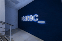 the word satec is lit up on a dark blue wall