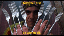 a man holding a bunch of forks with the words " may the forks be with us all " above him