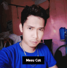 a man wearing a blue shirt has the name mesu cat on the bottom right