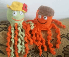 two crocheted octopus are sitting next to each other