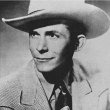 a man wearing a cowboy hat and a suit