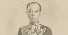 a black and white photo of a man in a suit with medals