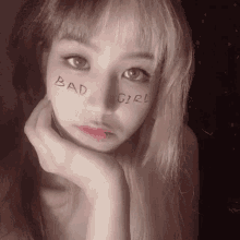 a woman with the word bad girl written on her face