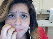 a woman with a ring on her finger looks at the camera