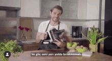 a man holding a vacuum cleaner in a kitchen with a caption that says ve güç seni yari yolda birakmal