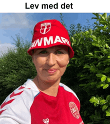 a woman wearing a red hat that says danmark on it