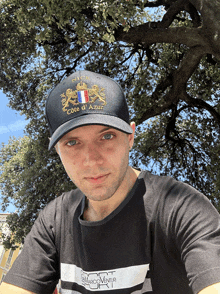 a man wearing a nice cote d' azur hat and a black shirt