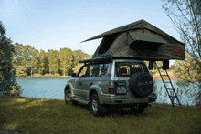 a toyota suv with a tent on top of it has a license plate that says jv-572-hl