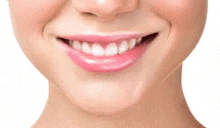 a close up of a woman 's smiling mouth with white teeth and pink lipstick .