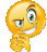 a yellow smiley face with green eyes is smiling and pointing at something .