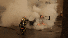 a fireman is spraying water on a burning vehicle