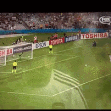 a soccer game is being played in a stadium sponsored by toyota and toshiba