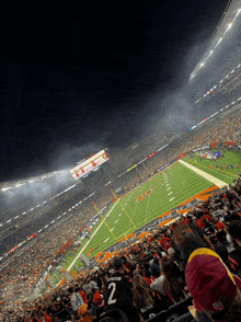 a football game is being played in a stadium and the number 2 is on the back of the jersey