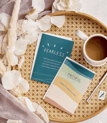 a book called fearless sits next to a book called faithful on a tray