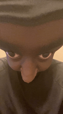 a close up of a person 's face with a very long nose