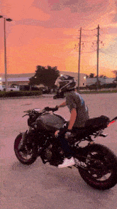 a man is riding a motorcycle with a helmet on