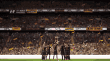 a group of soccer players holding up a trophy in front of a crowd that says ' coca cola ' on it