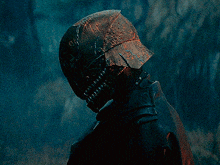 a close up of a person wearing a helmet in a dark room .