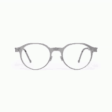 a pair of round glasses with a gray frame and clear lenses on a white background .