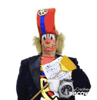 a clown is holding a clock and a piece of paper that says ' creative discov ' on it