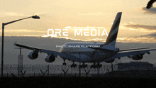 a large passenger jet is taking off from an airport with the words ore media photo share platform below it