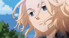 a close up of a blonde anime character 's face with trees in the background