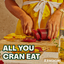 a woman in a yellow apron is cutting vegetables on a cutting board with the words " all you cran eat " above her