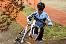 a man riding a bike with a shirt that says rmati on the arm