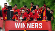 a group of soccer players are on a bus with the word winners on it