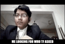 a man in a suit and glasses is looking for someone