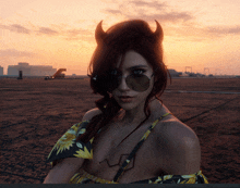 a woman wearing horns and sunglasses stands in a field