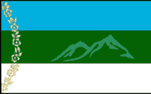 a blue and green flag with a mountain in the background