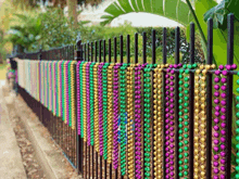 a fence is decorated with beads of different colors