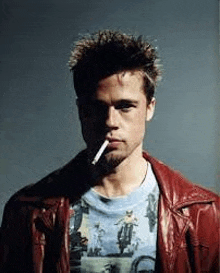 a man in a red leather jacket is smoking a cigarette in his mouth .