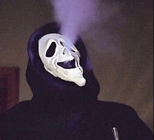 a person wearing a scream mask with smoke coming out of it 's mouth .