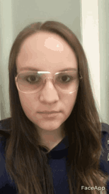 a woman wearing glasses and a blue shirt has faceapp written on the bottom of her face