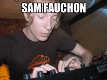 a man in a brown shirt is playing a mixer with the name sam fauchon written on the bottom .