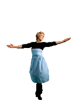 a woman in a blue and black dress is standing with her arms outstretched