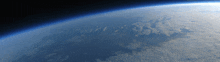 a view of the earth from space with clouds and mountains