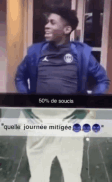 a man in a blue jacket stands next to a screen that says 50 % de soucis