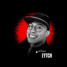 a man wearing glasses and a hat with the name eytch