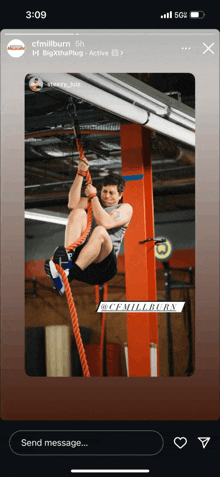 a phone screen shows a picture of a man climbing a rope at cfmillburn