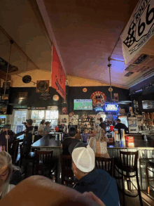 a budweiser sign hangs from the ceiling of a restaurant