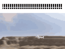 a plane is flying over a desert landscape with exclamation points on the bottom