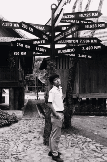 a man stands in front of a sign that says ' mazon ' on it