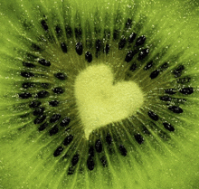 a close up of a kiwi with a heart shaped center