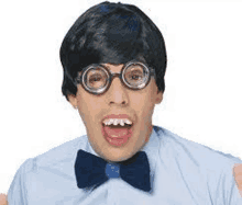 a man wearing a wig , glasses , a bow tie and a bow tie is making a funny face .